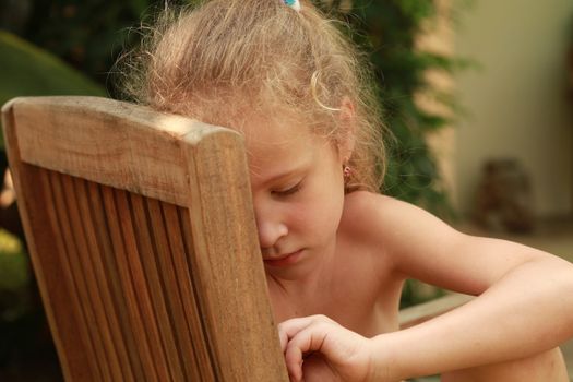 a sad child is sitting on a chair