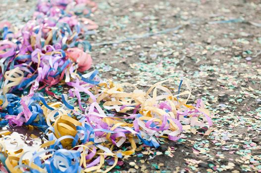 colorful confetti and streamers at the street after Carnival Parade (shallow DOF)