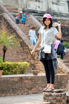 Asian woman enjoying at Buddhist temple in Thailand. 