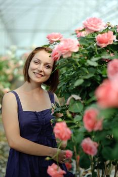 An image of a young woman in the greenhouse