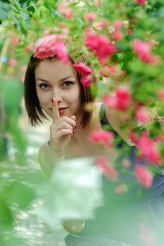 An image of a young beautiful woman amongst roses