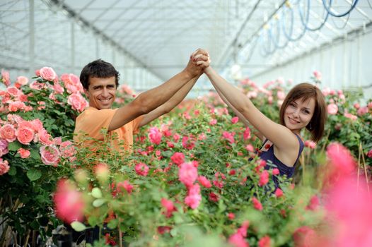 An image of a young couple in a greenhouse