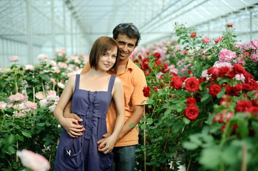 An image of a woman and a man in greenhouse