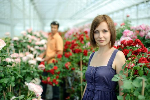 An image of a woman and a man in a greenhouse