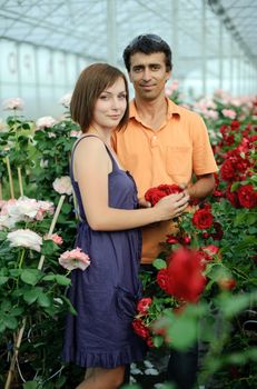 An image of a woman and a man in a greenhouse