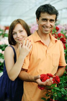 An image of a young couple in a greenhouse