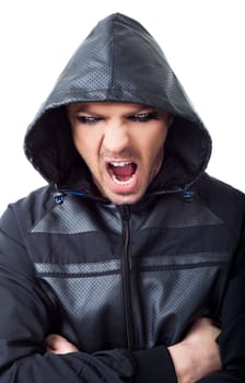 Young male gangster with black hood looking at camera screaming hands on chest