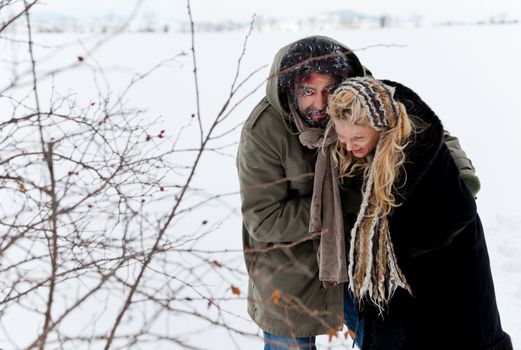 Frozen homeless couple struggling in winter time or kidnaping