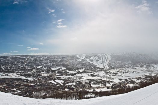 Panorama of  winter mountain slopes with ski routes and snowstorm approaching from the east taken in Geilo, Norway