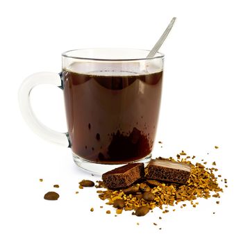 Coffee in a glass mug, a spoon, grains and granules of coffee on the table with a dark porous chocolate isolated on white background