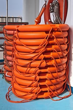 Plastic orange life buoys at a ship deck