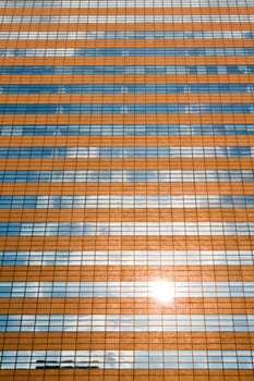 Facade of a modern skyscraper reflecting sun