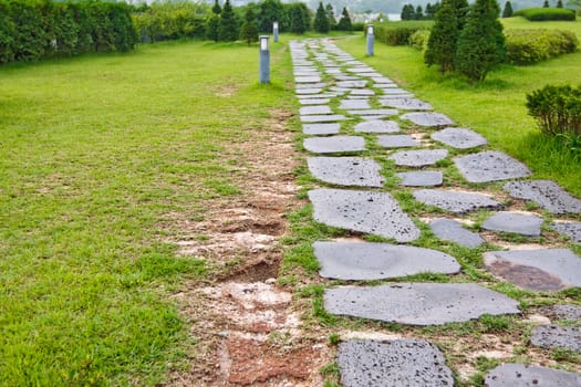Park  track paved with a natural stone on the lawn
