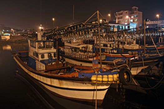 Fishing boats at night in small korean port