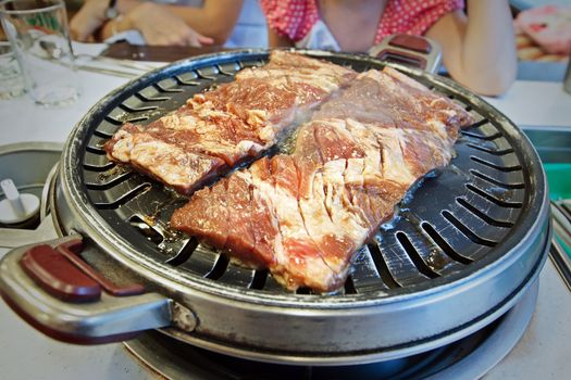 Two pieces of fresh raw meet on Korean style grill