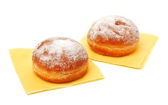 two donuts in powdered sugar on paper napkins
