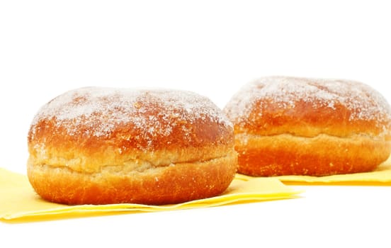 two donuts in powdered sugar on paper napkins