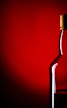 bottle of whiskey on red background