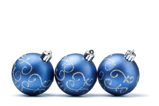 three blue decoration balls isolated on white