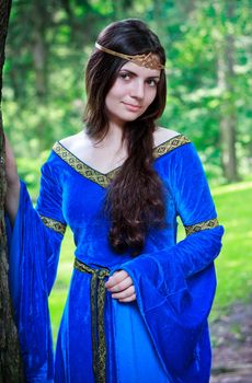 beautiful princess standing in shadow of big tree