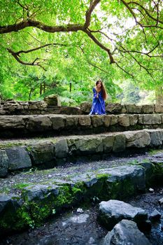 beautiful elf princess sitting on stone staircase