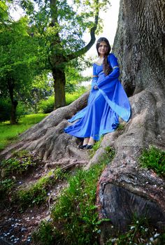 beautiful elf princess in roots of big tree