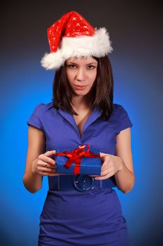 beautiful christmas girl with gift, blue background