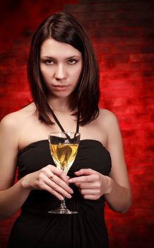 beautiful girl with glass of wine, red background