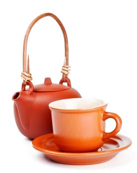 clay kettle and cup with saucer isolated on white