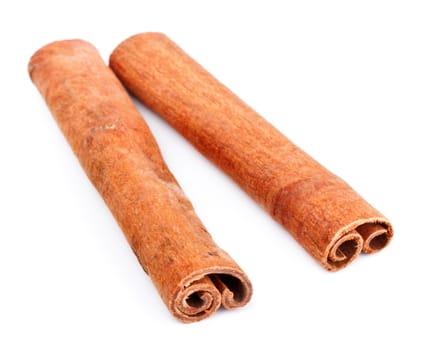 two cinnamon sticks isolated on white background