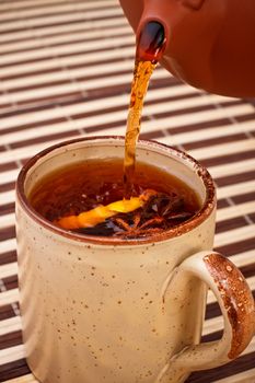 mug of winter tea with star anise on bamboo napkin