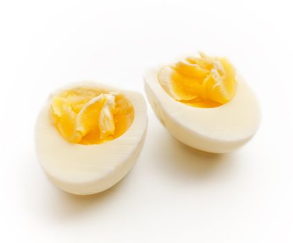 hard boiled egg sliced in half, gray background