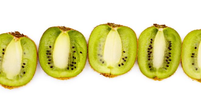 kiwi halves laying in row, white background