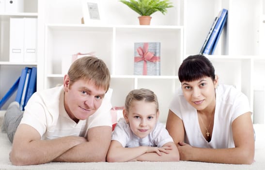 Portrait of happy family lying together, hugging and happy