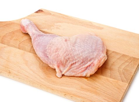 fresh chicken thigh laying on cutting board