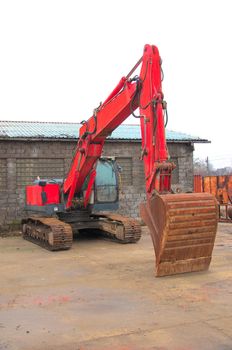 Red excavator on a construction site