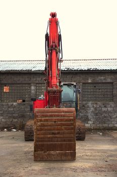 Red excavator on a construction site