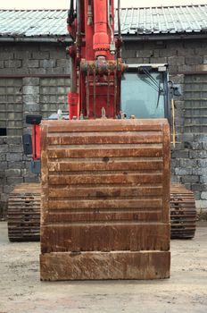 Red excavator on a construction site