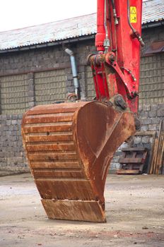 Red excavator on a construction site