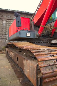 Red excavator on a construction site