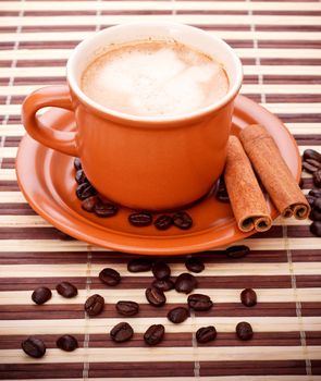 fresh coffee cup and beans on bamboo napkin