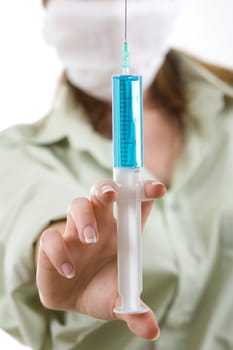 An image of nurse in a mask with an injection