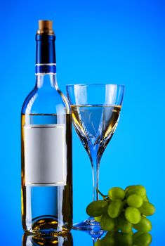 bottle and glass of wine, grape bunch, blue background