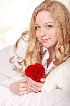 pretty girl in bed with red rose