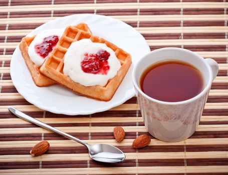 dessert with soft waffle, tea and raspberry jam