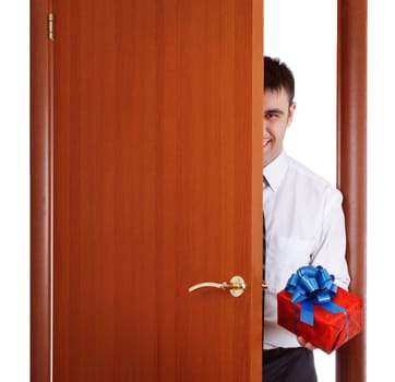 young man with gift opening the door