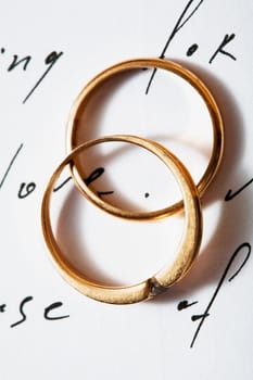 Stock photo: an image of two golden rings on a letter