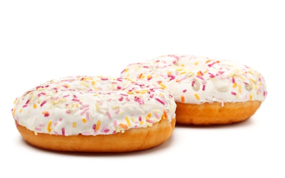 two sugar glazed donuts covered in sprinkles isolated on white