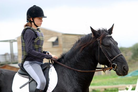 training in dressage for a black horse and her riding girl