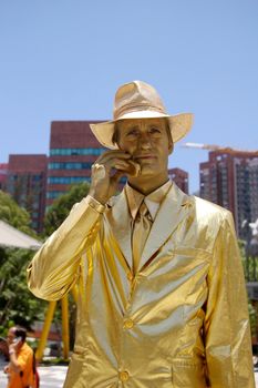 HONG KONG - JUL 22, A man is painting all in gold color along the street to celebrate Beijing Olympic Games in Hong Kong on 22 July, 2010.